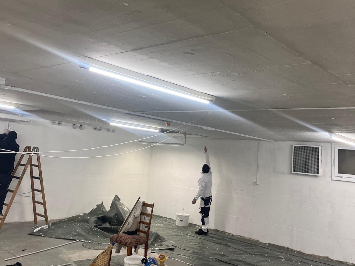 Maler streicht eine Decke im Innenausbau
